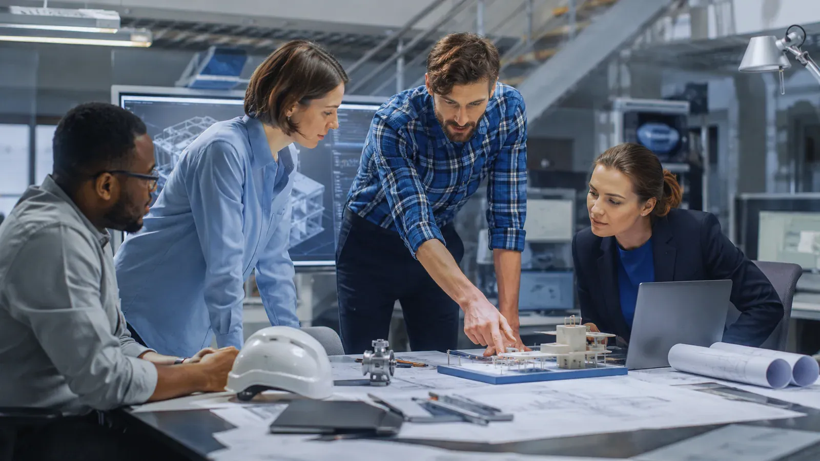 Engineering project team coordinating delivery together